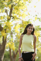 teen girl standing under blooming tree