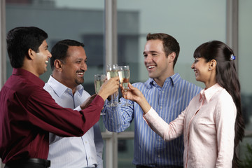 Mixed raced group toasting eachother