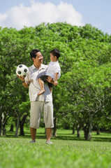 Father carrying young son
