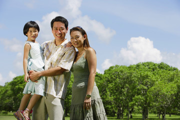 Family with one child outdoors, portrait