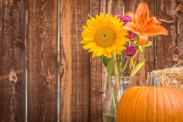 Still life of pumpkin and autumn flowers.