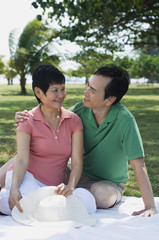 Mature couple having a picnic in the park