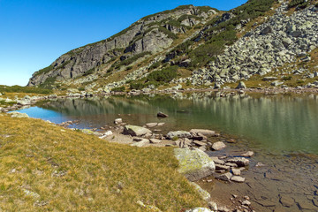 Fototapeta na wymiar Reflection of green hills in small Lake, Rila Mountain, Bulgaria