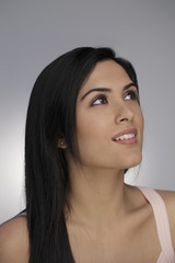 Head shot of young woman looking up