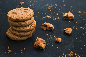 Oatmeal chocolate chip cookies. Cookies on wooden background. Cookies crumbs.