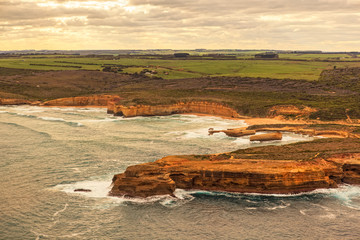 Obraz na płótnie Canvas An aerial view of the 12 Apostles, a collection of limestone stacks off the shore of the Port Campbell National Park, by the Great Ocean Road in Victoria, Australia