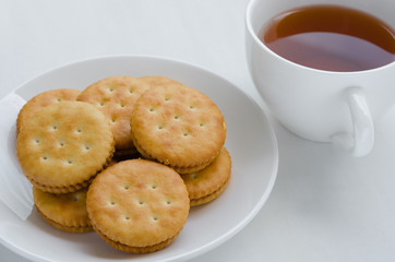 Sandwich Cream Crackers with Hot Tea for Breaking Time.