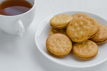 Sandwich Cream Crackers with Hot Tea for Breaking Time.