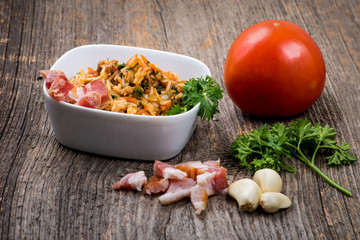 Minced meat with rice, tomato, garlic, parsley, kaiser and on wood background