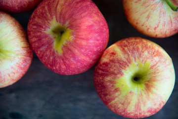 Ripe red apples on wooden background