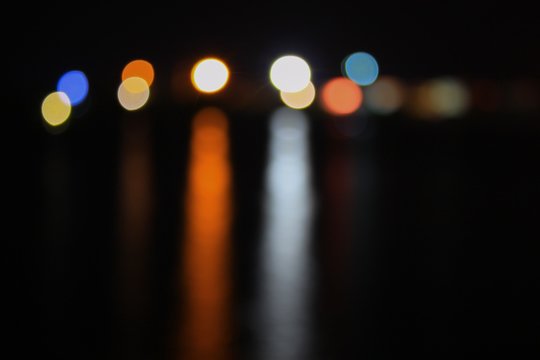 Abstract night light bokeh, Blur blurred River with reflex in water