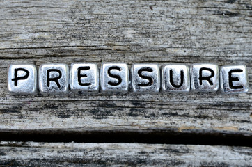 cube word pressure on table
