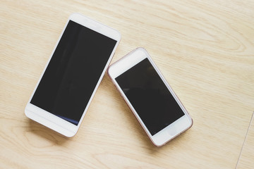 hand holding the white smartphone on blurred background