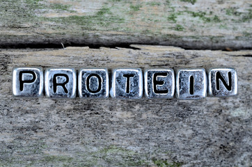 cube word protein on wooden table