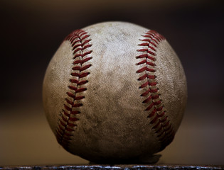 Close up of professional sized well used and weathered baseball
