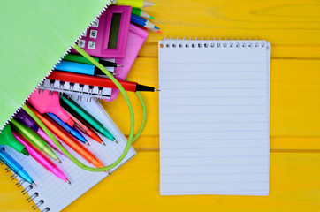 notebook and supplies for school in bag on  table