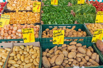 Potatoes and other vegetables for sale at a market