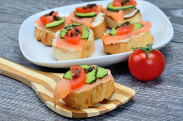 bruschette salmon on brown wooden spoon