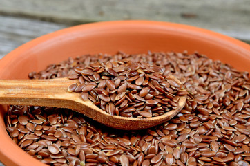 flax seed in bowl with spoon on table