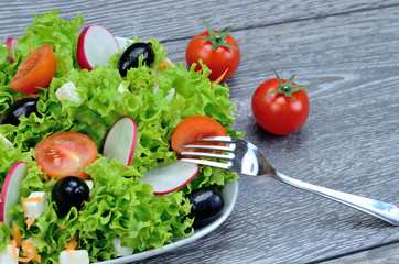 salad and fork in dish on table