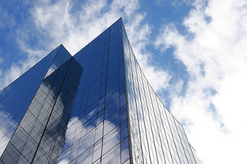 low angle view of office building against blue sky and white cloud