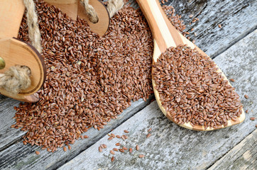 flax seed on table with spoon and bucket