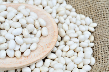 white beans on wooden spoon