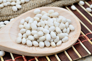 white beans in spoon on table