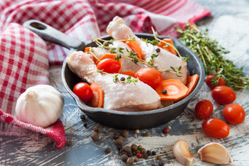 chicken legs and tomatoes in ware for roasting, selective focus