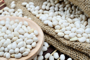 white beans in spoon on table