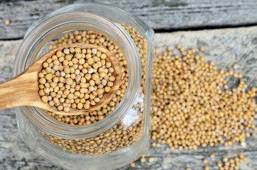 mustard seed in spoon on jar