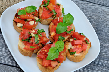tomato bruschetta in white dish on table