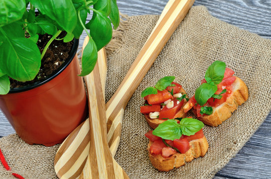 tomato bruschetta and basil on rustic clooth