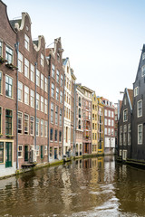 Obraz premium Beautiful view of Amsterdam canals with bridge and typical dutch