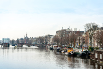 Beautiful view of Amsterdam canals with bridge and typical dutch