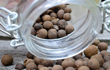 allspice in jar on table
