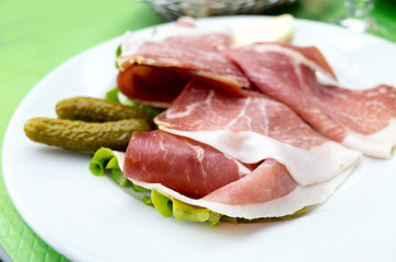 close up of tasty cold meats on the table