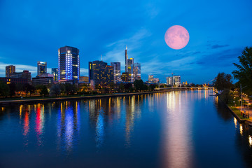 Skyline of Frankfurt am Main (Germany) at dusk with super moon 