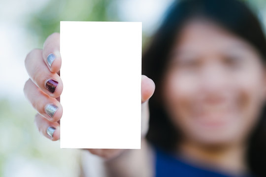 Close up hand asia woman hold blank card with nature background.Business concept.