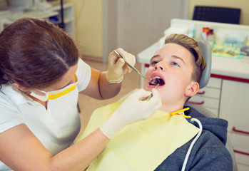 boy is treated by female dentist