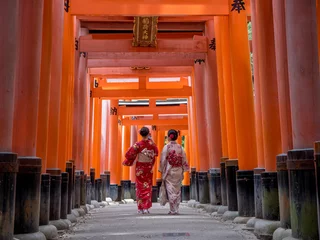Badkamer foto achterwand two girls in kimonos, one taking a selfie, in the torii gates, Fushimi Inari Shrine in Kyoto, Japan © John