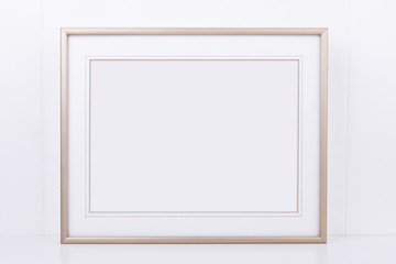 Mockup plain thin landscape gold frame on a white background overlay your quote promotion headline...