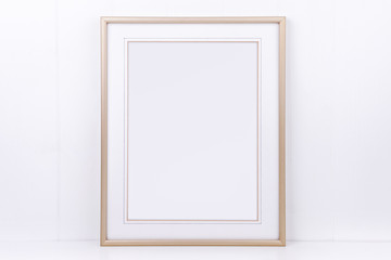 Mockup plain thin portrait gold frame on a white background overlay your quote promotion headline...