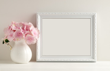 Fototapeta na wymiar White landscape frame mockup, vase of hydrangea, overlay your quote promotion headline or design great for small businesses lifestyle bloggers & social media campaigns