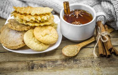 delicious cookies and Cup of hot tea with a cinnamon stick