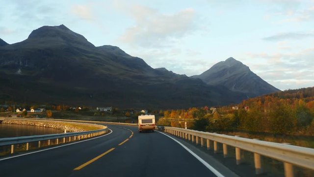 Driving on route E8 toward the city of Tromso, on a nice evening sunset, in north Norway
