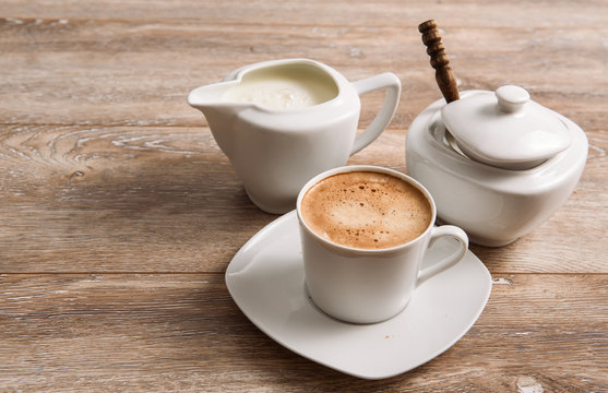 Coffee With Milk And Sugar On Wooden Table.