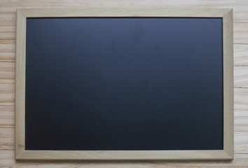 Fototapeta na wymiar Chalk board hanging on wooden background