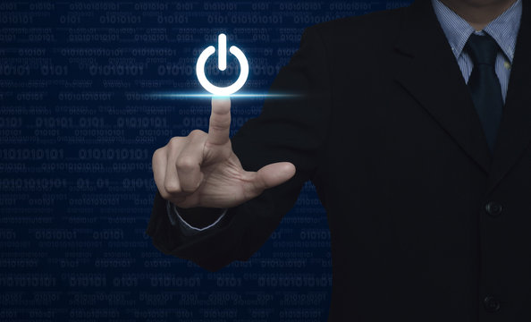 Businessman pressing power button over computer binary code blue - Powered by Adobe