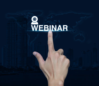 Hand pressing webinar icon over map and city tower, Seminar onli